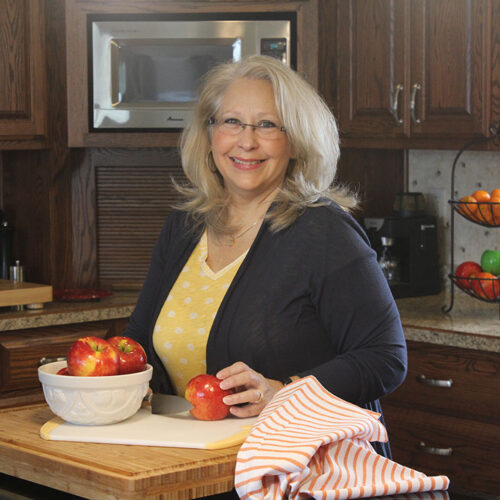 photo of Kymberley standing in her kitchen