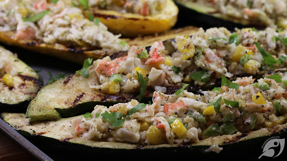 Close-up of Crab-Stuffed Zucchini and Summer Squash Boats fresh from the grill on a tray.