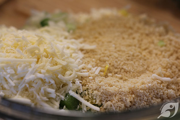 showing the breadcrumbs and Romano cheese added to the bowl.