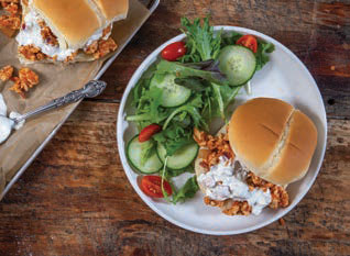 one buffalo chicken sloppy joe on a plate with salad