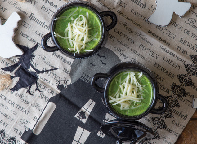 soup served in black cauldron soup bowls with halloween table setting