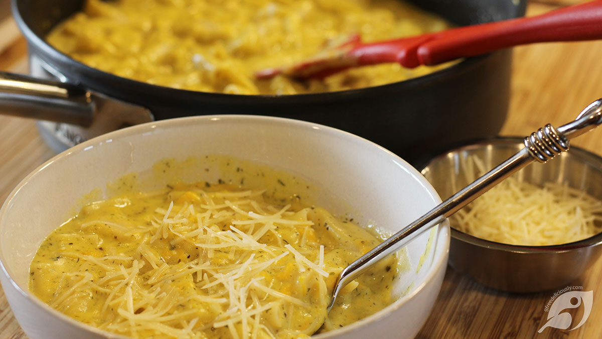 closeup of pumpkin Mac & Cheese in a bowl with pan in background