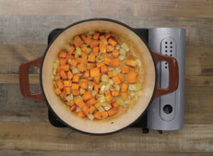 Onions and sweet potatoes in a pot, step 1