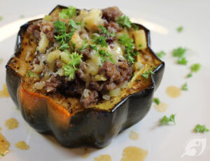one serving (one half) stuffed acorn squash on a plate