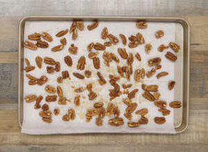 pecan halves arranged on a sheetpan to dry