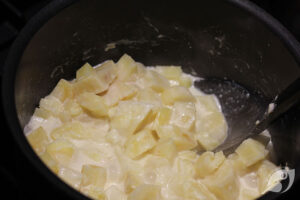 cooked parsnips with milk, cream, butter in a pan