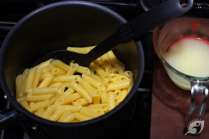 Step 3 - Add the penne pasta to the boiling water and cook according to the instructions: drain, and reserve about ½ cup of the pasta cooking water.
