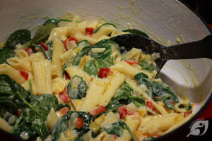 Step 5 - Before serving, add one or two handfuls of fresh baby spinach, tossing lightly to combine, and wilt the spinach.
