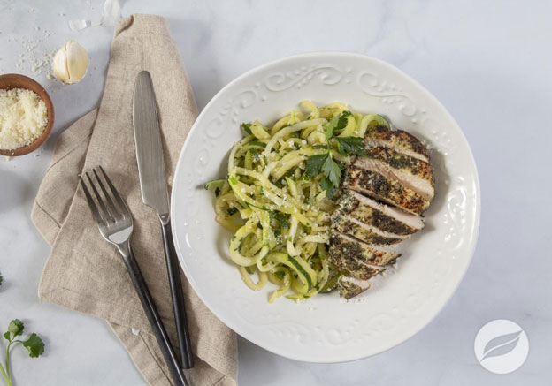 Lemon Garlic Butter Chicken & Zoodles plated with knife fork and napkin on the side of the dish