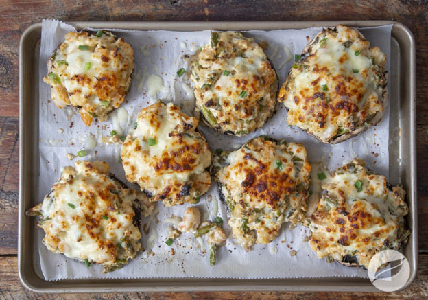 Shrimp Alfredo Stuffed Portabellas on parchment on a sheetpan