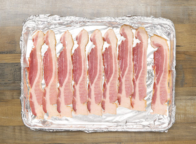 Bacon strips on a sheet pan covered with foil