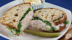 Ham Salad Sandwich Spread on a plate with pickle, cottage cheese in background