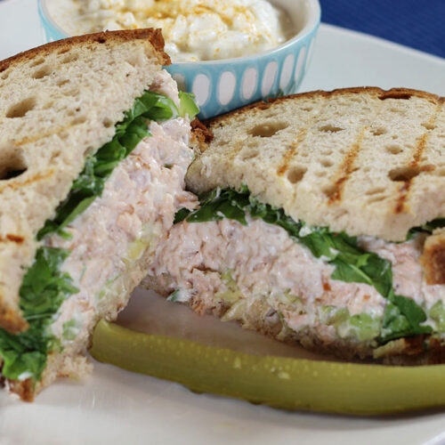 Ham Salad Sandwich Spread on a plate with pickle, cottage cheese in background