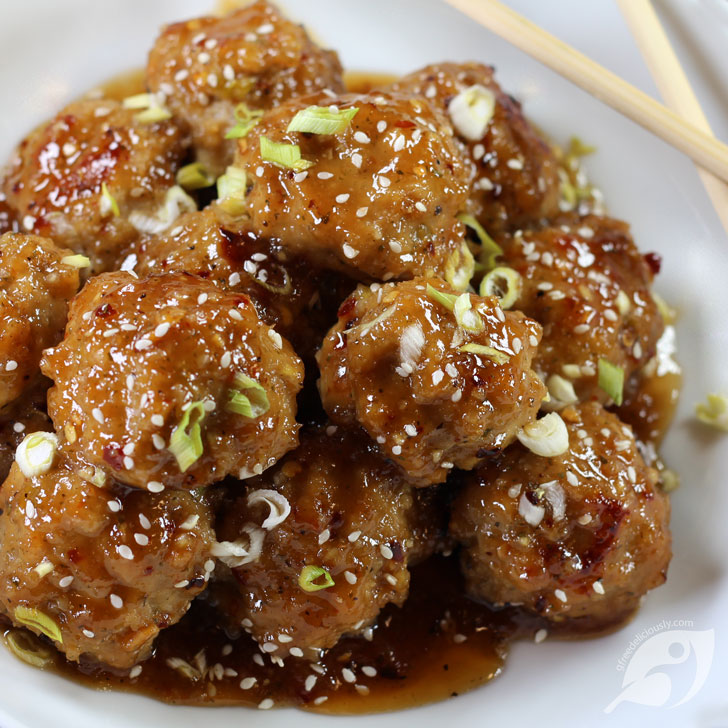 Baked Orange Chicken Meatballs on a plate with chopsticks.