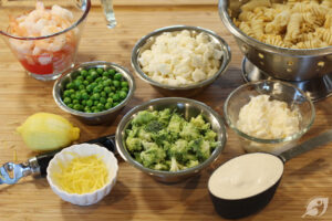 While the pasta is cooking, rinse and drain the broccoli and cauliflower under cool water. You’ll want to make sure to drain it well, cut off any bad spots, then cut down the florets into small pieces. Finally, zest the lemon and measure out the remaining ingredients.
