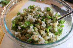 Roughly chop the reserved zucchini flesh from step one, then add the onion, pepper, and Italian seasoning blend to a bowl. Stir to combine.