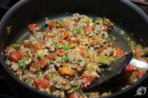 Mixed vegetables and tomatoes in the skillet with the liquid dried up.