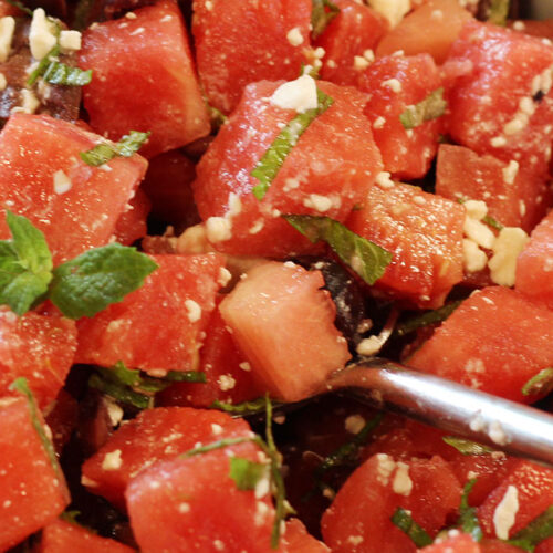 A serving bowl with Watermelon, Mint, and Feta with Kalamata Olives