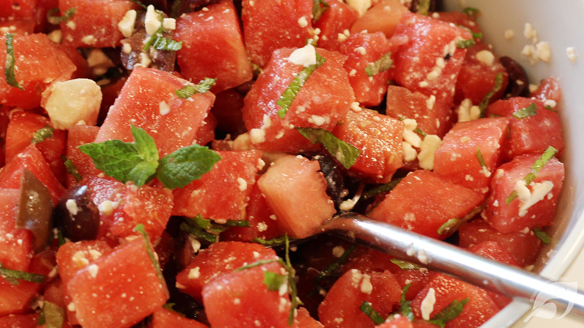 A serving bowl with Watermelon, Mint, and Feta with Kalamata Olives