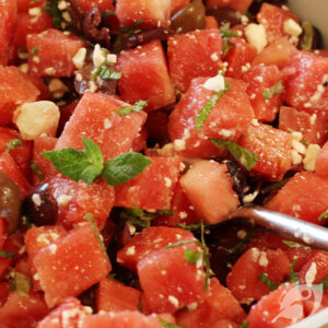 A serving bowl with Watermelon, Mint, and Feta with Kalamata Olives