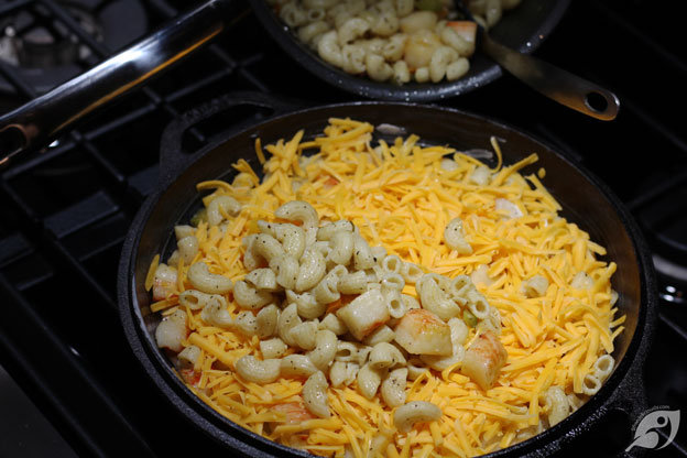 Then cover the layer with half of the grated Colby cheese. Repeat with another layer of the remaining macaroni, pepper, and lobster mixture.