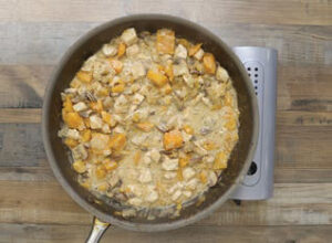 Step 2 - Butternut Squash & Mushroom Chicken (or Turkey) Pot Pies: Next, add the Pot Pie Skillet Meal Seasoning and stir to coat the ingredient mixture. Once combined, add the chicken broth and ½ cup cream, then simmer for 5 minutes or until the liquid thickens into a sauce.