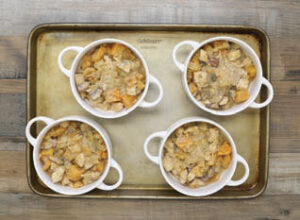 Step 3 - Butternut Squash & Mushroom Chicken (or Turkey) Pot Pies: Transfer the mixture into four oven-safe ramekins, filling equally almost to the top.