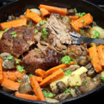 Beef Pot Roast with carrots, parsnips, mushrooms, and pearl onion in a cast iron dutch oven