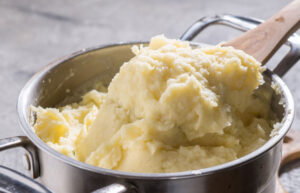 Then add the butter and a splash of milk (a little at a time), mashing until smooth, and season to taste.