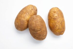 Three raw russet potatoes