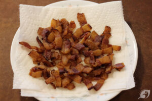 Cook bacon according to your favorite method until each strip is uniformly crisp, then dice into small pieces.