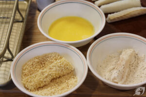 The cut sticks are coated with the flour mixture, then the flour-coated fish is dipped in the egg wash to cover all sides of each portion. Finally, roll in the panko crumbs before placing them on a lightly sprayed air-fryer basket.