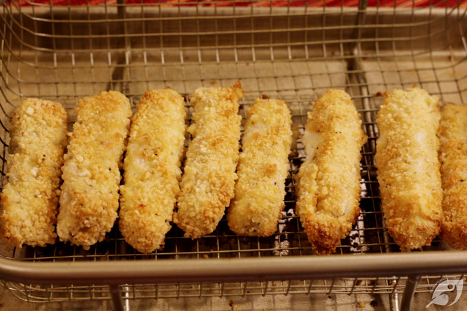 Air fry at 375°F (190°C) for approximately 6-7 minutes, flip over, and spray lightly with more coconut oil, then continue cooking for an additional 6-7 minutes or until the coating becomes golden brown and lightly crispy.