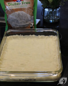 Press the mixture onto the bottom of a 13x9-inch baking pan—Bake at 350°F (177°C) for 15 minutes.