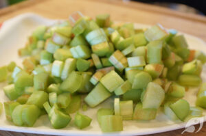Meanwhile, prepare the filling while the crust is baking. Begin by dicing the rhubarb stems into 1/2-inch pieces, then set them aside.