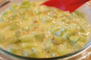 Fold in the diced rhubarb. Spread the mixture over the hot crust.