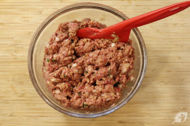 Next, add the breadcrumb mixture to the beef and pork mixture, stirring everything gently to combine.