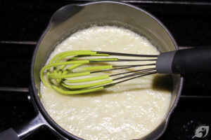 Melt three tablespoons of butter in a small saucepan over medium-low heat, immediately whisk in the flour and simmer for 1-2 minutes to make a white roux that is slightly puffed and bubbly.