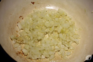 Heat the grapeseed oil over medium heat in a heavy-bottom pot or Dutch Oven. Sauté the chopped onion for 4-5 minutes to soften and become translucent, then add the minced garlic and ginger, continuing to cook for about two minutes until everything becomes fragrant.