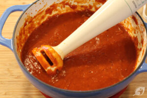 Using an immersion blender, purée the sauce in the pot until smooth.