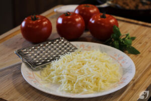 Preheat the oven to 400°F. Cook rice according to package directions. Prepare the baking dish by drizzling a small amount of olive oil over the bottom. Grate the cheese and set it aside until needed.