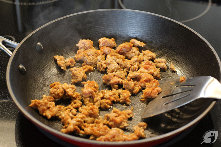 Cook the sausage by browning it in an 8-inch skillet over medium-low heat, breaking it into small pieces as it cooks.