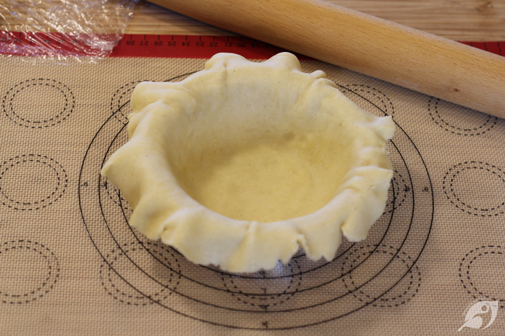 Transfer the dough to the pie plate. Remove the top piece of plastic wrap and invert the crust into the prepared pie plate.