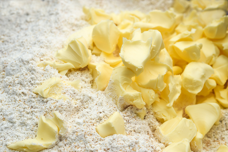 Cut the cold butter into pats and add to the flour mixture.