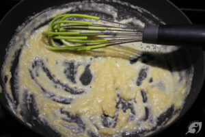 Once the butter has fully melted, stir the gluten-free flour into the butter until uniform paste forms.
