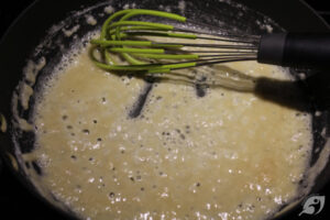 Continue whisking the roux for a minute or two to thoroughly cook the flour while being careful not to burn the mixture. Tiny bubbles should appear.