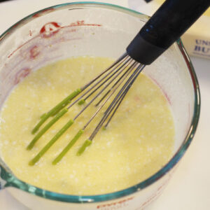 The photo shows the flour whisked into the measuring cup with the scaled milk and melted butter.